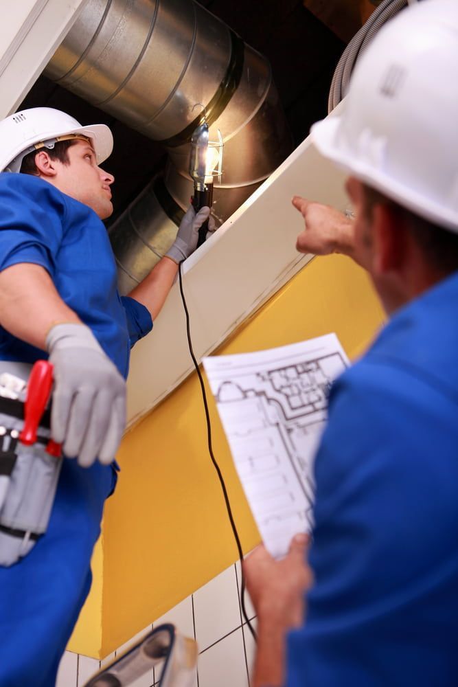 Two Men with Hard Hats Working on A Ventilation System — Gordon's Air Conditioning & Refrigeration Services in Caloundra, QLD