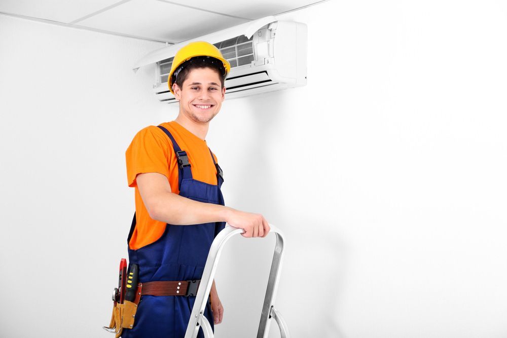 A Man Is on A Ladder Next to An Air Conditioner — Gordon's Air Conditioning & Refrigeration Services in Maroochydore, QLD