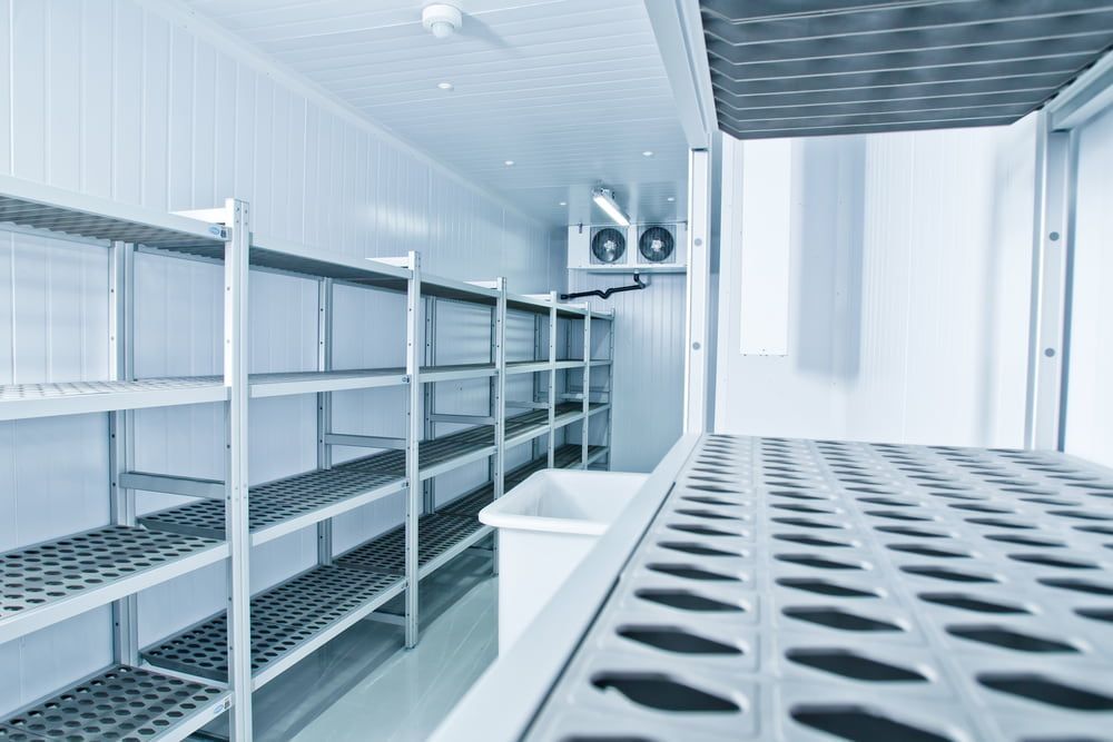 Empty Refrigerated Room with Metal Racks — Gordon's Air Conditioning & Refrigeration Services in Caloundra, QLD