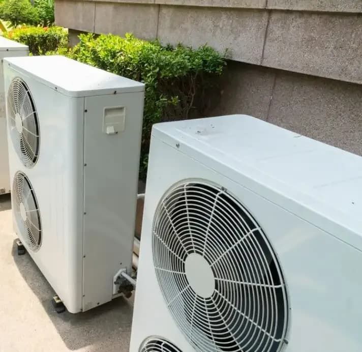 Two White Air Conditioners Exhaust — Gordon's Air Conditioning & Refrigeration Services in Sunshine Coast, QLD