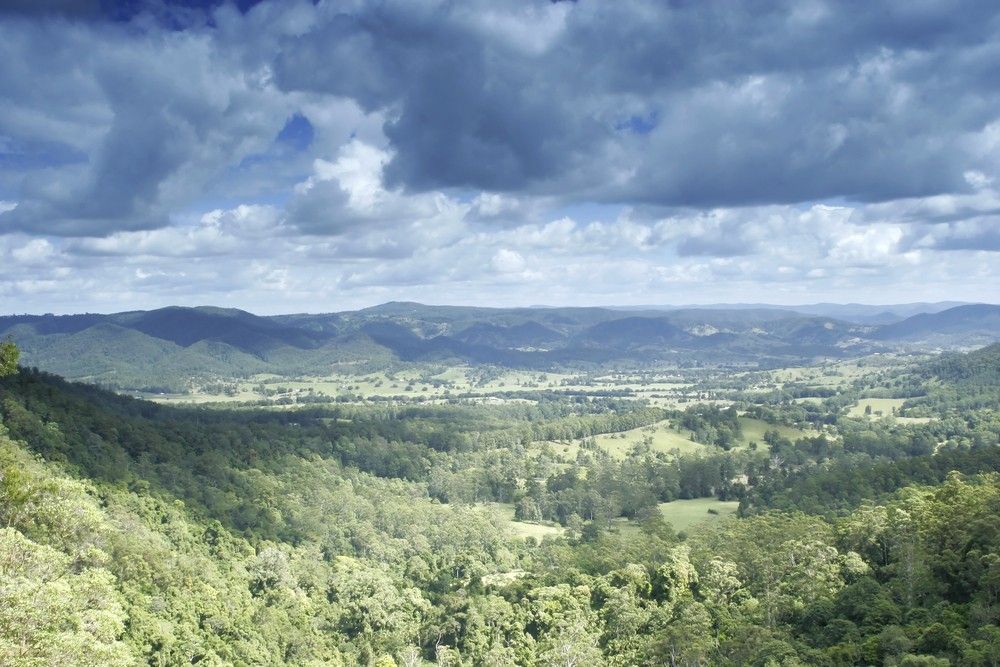 Green Valley with Rolling Hills Under a Cloudy Sky β Gordon's Air Conditioning & Refrigeration Services in Mapleton, QLD