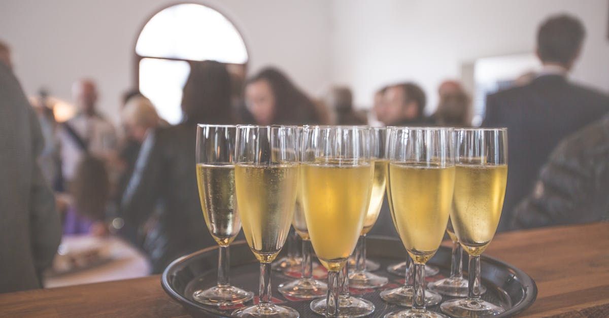 A tray of champagne glasses on a table at a party.