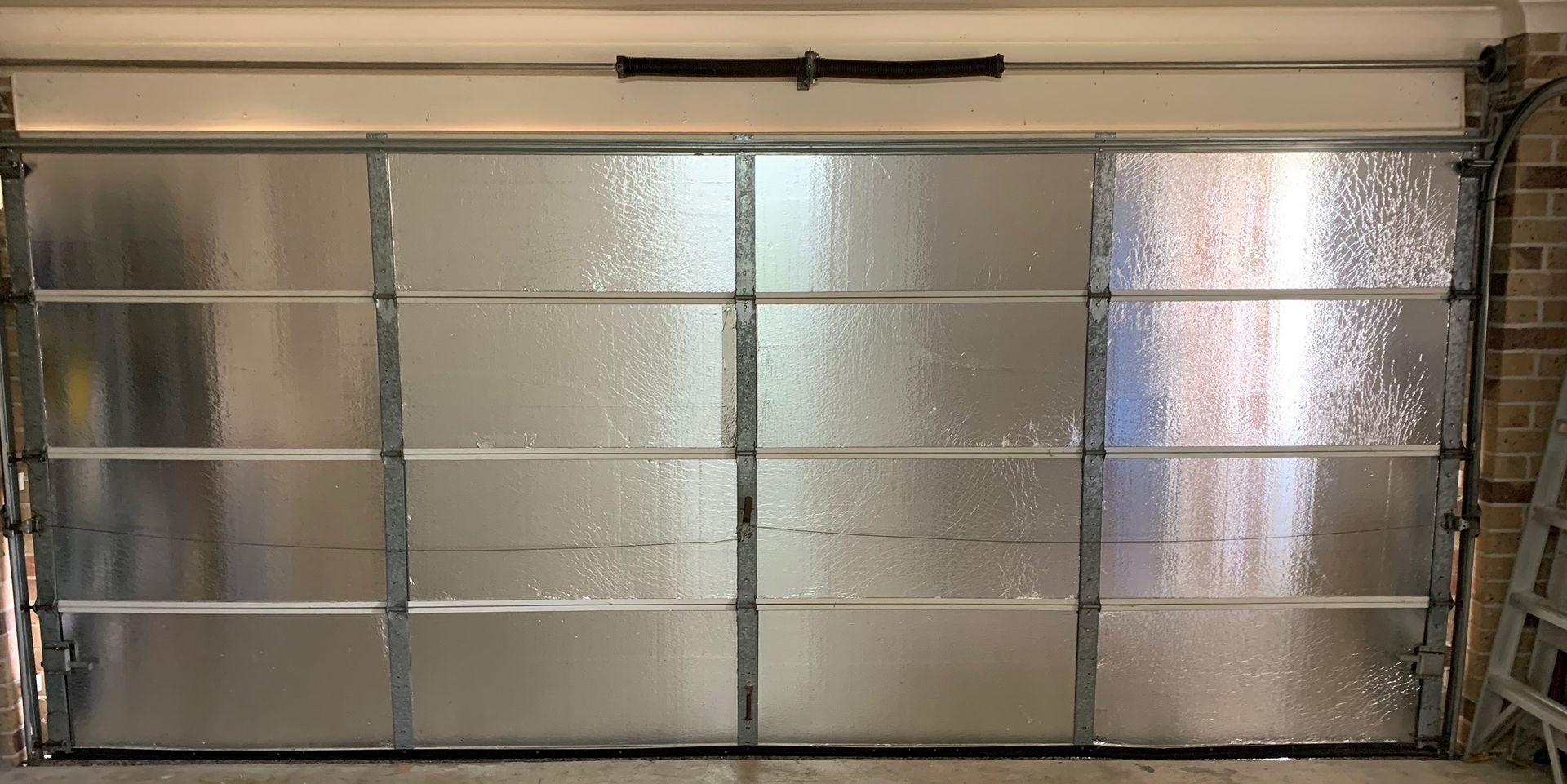 Frosted glass garage door with metallic frame.
