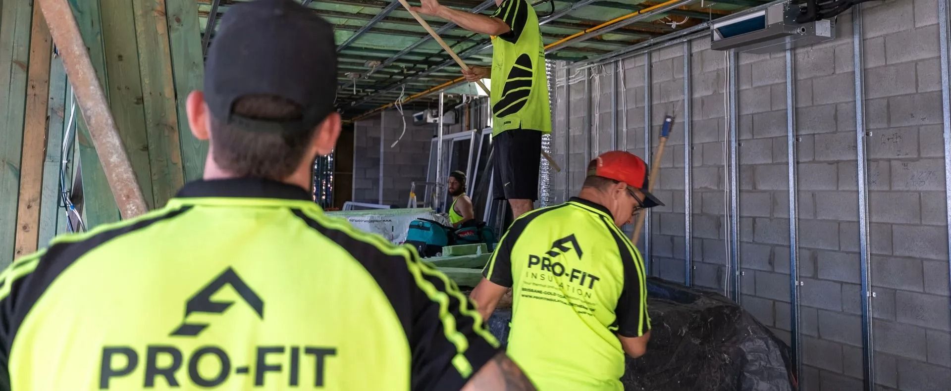 Workers in neon shirts with