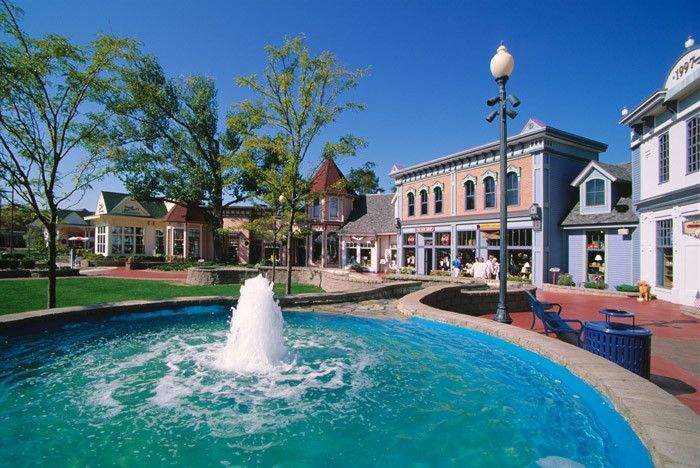 A small town with a fountain in the middle of it