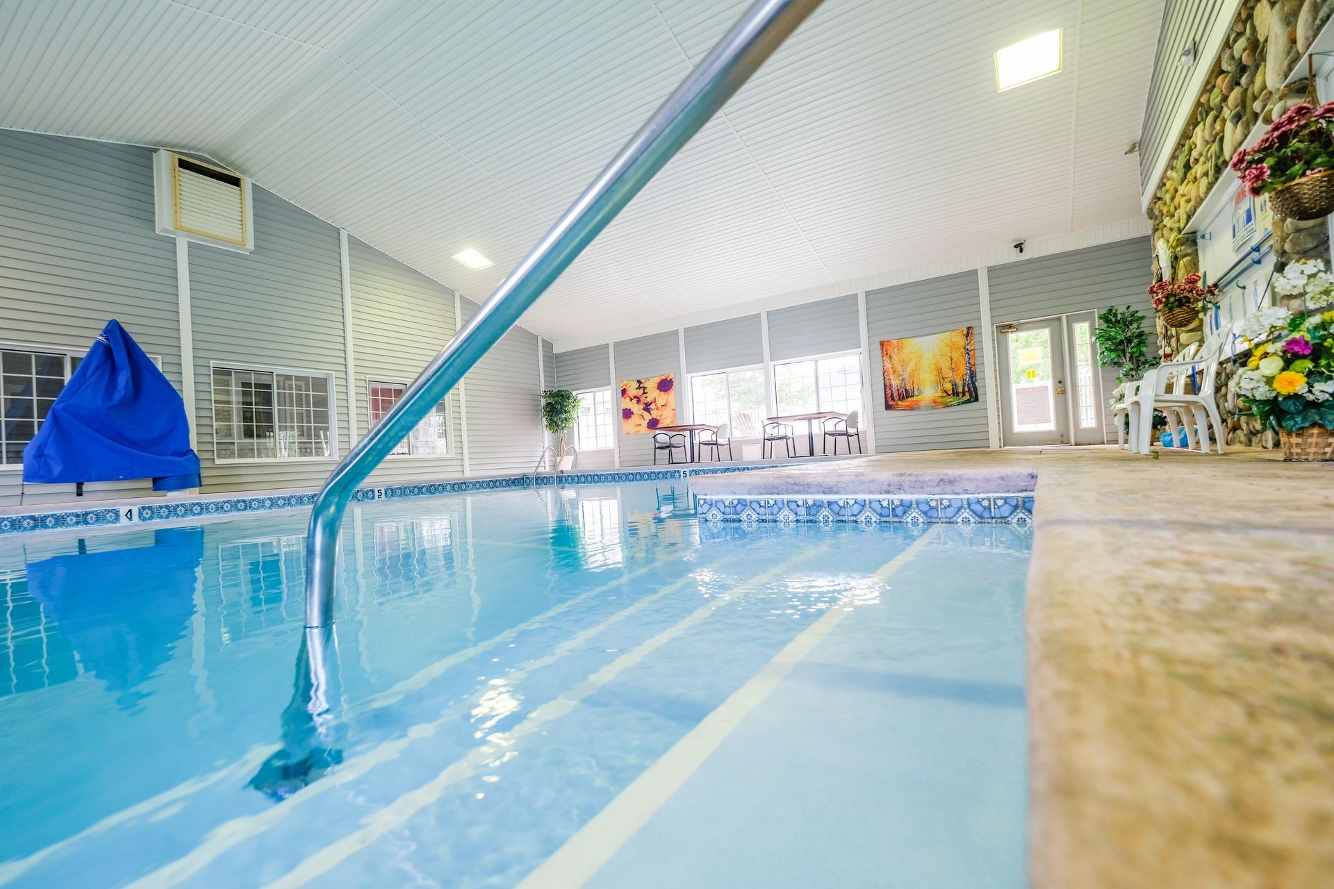 A large indoor swimming pool with a staircase leading to it.