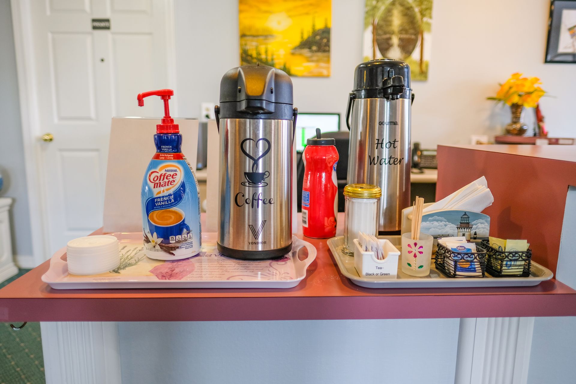 A table with a variety of drinks and bottles on it.