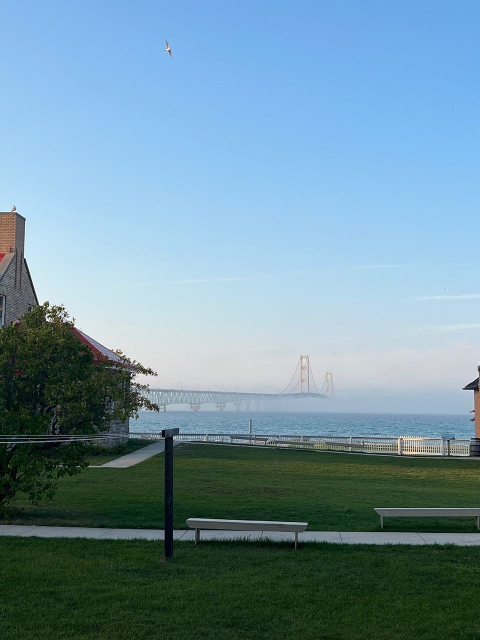 There is a bridge in the distance and a house in the foreground.
