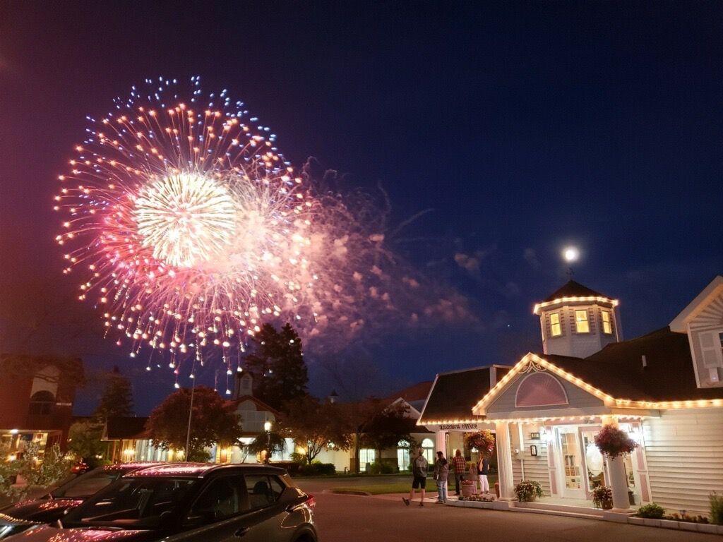 A fireworks display is taking place in front of a building