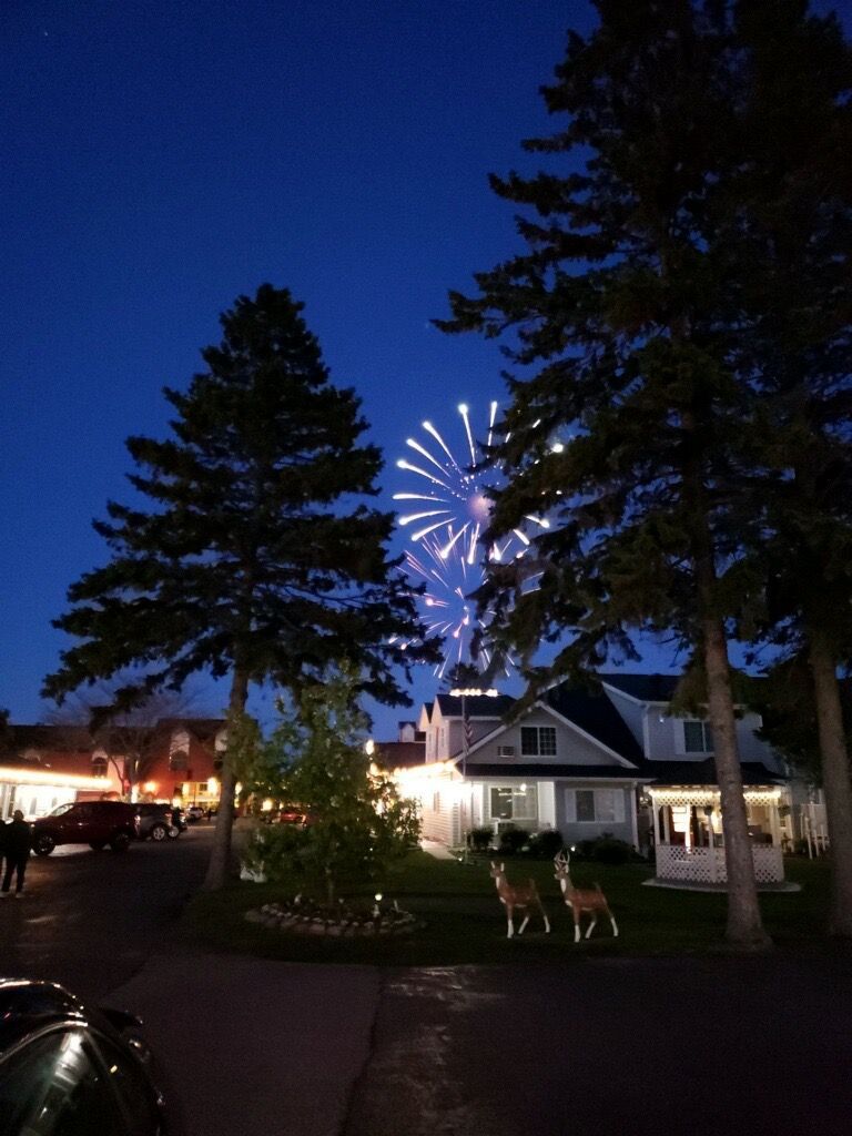 A house with a fireworks display in the background