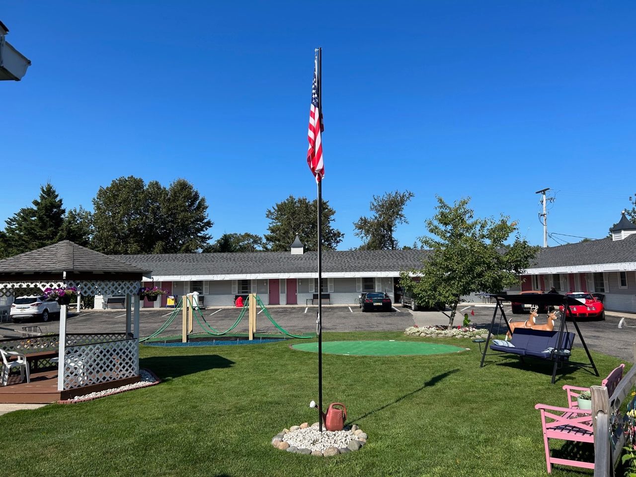 An american flag is flying in front of a motel