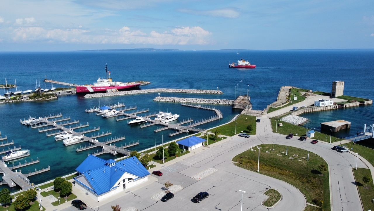 An aerial view of a marina with boats docked in the water.