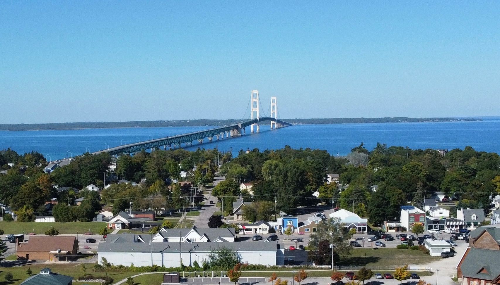 An aerial view of a small town with a bridge over a body of water.