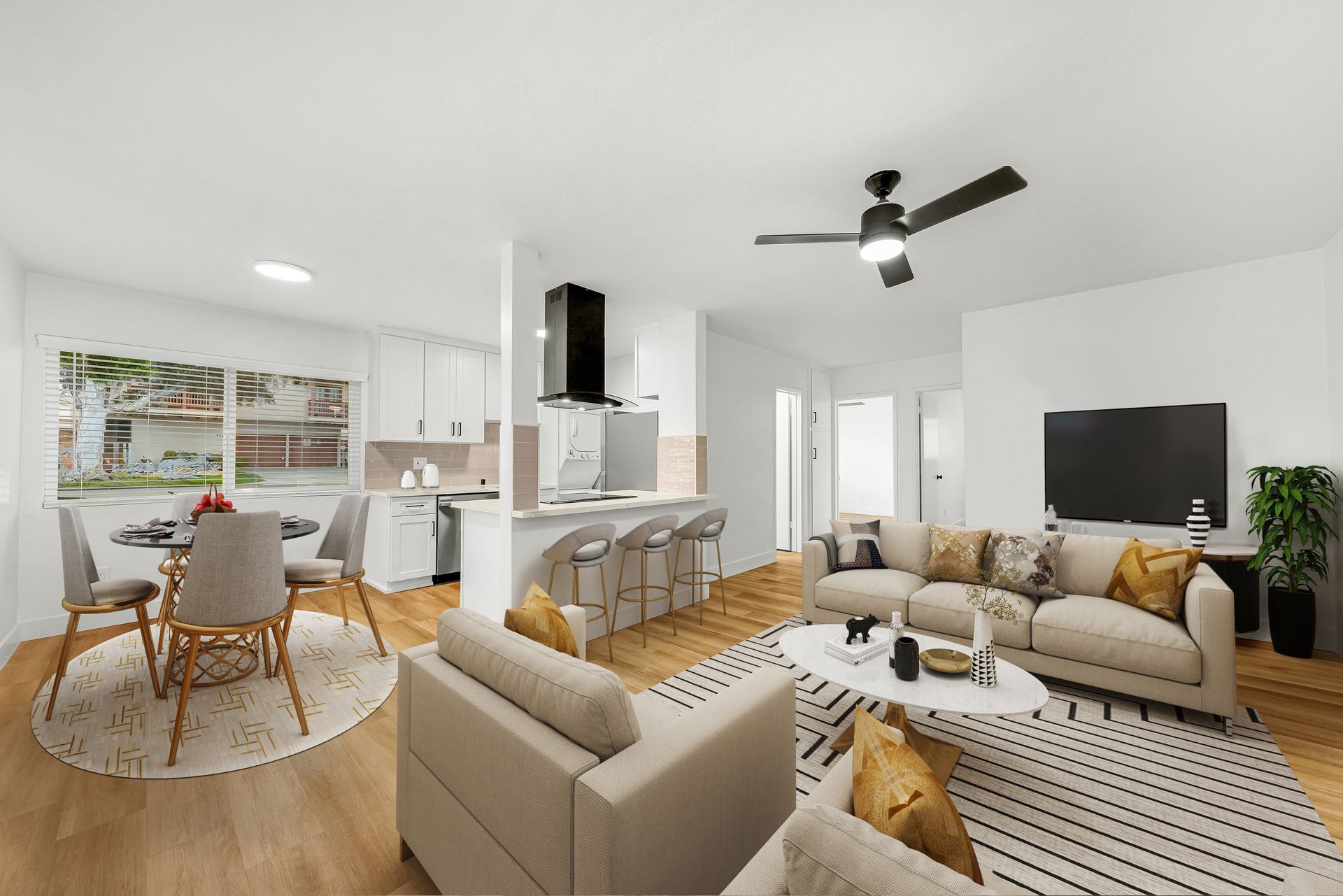 A living room filled with furniture and a ceiling fan.