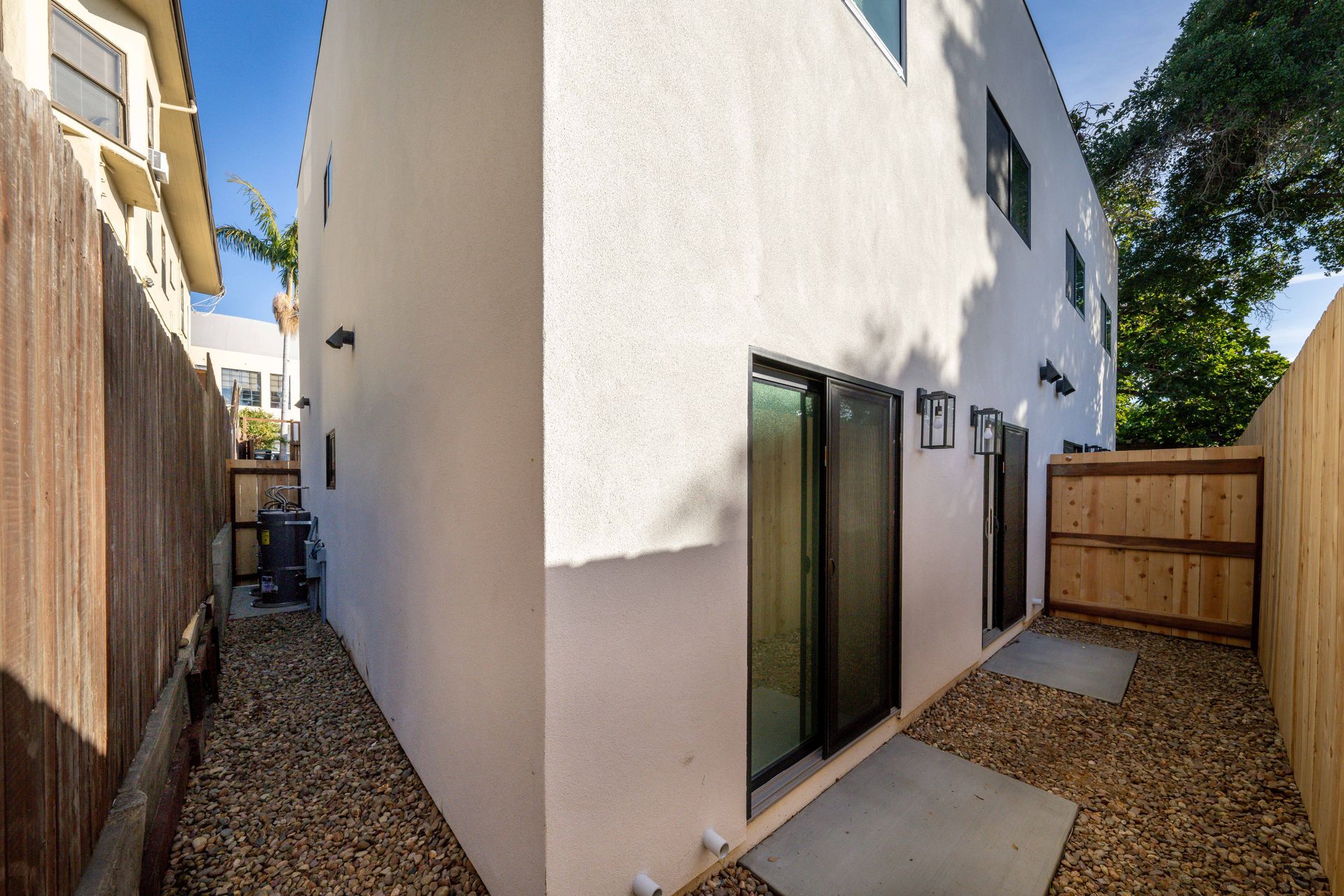 A white house with a wooden fence in the backyard