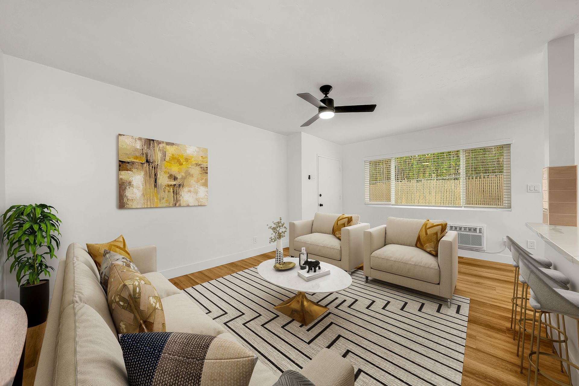 A living room with two couches , a coffee table , and a ceiling fan.