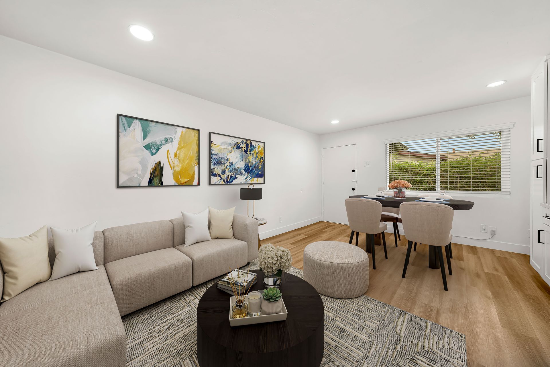 A living room with a couch , table and chairs.