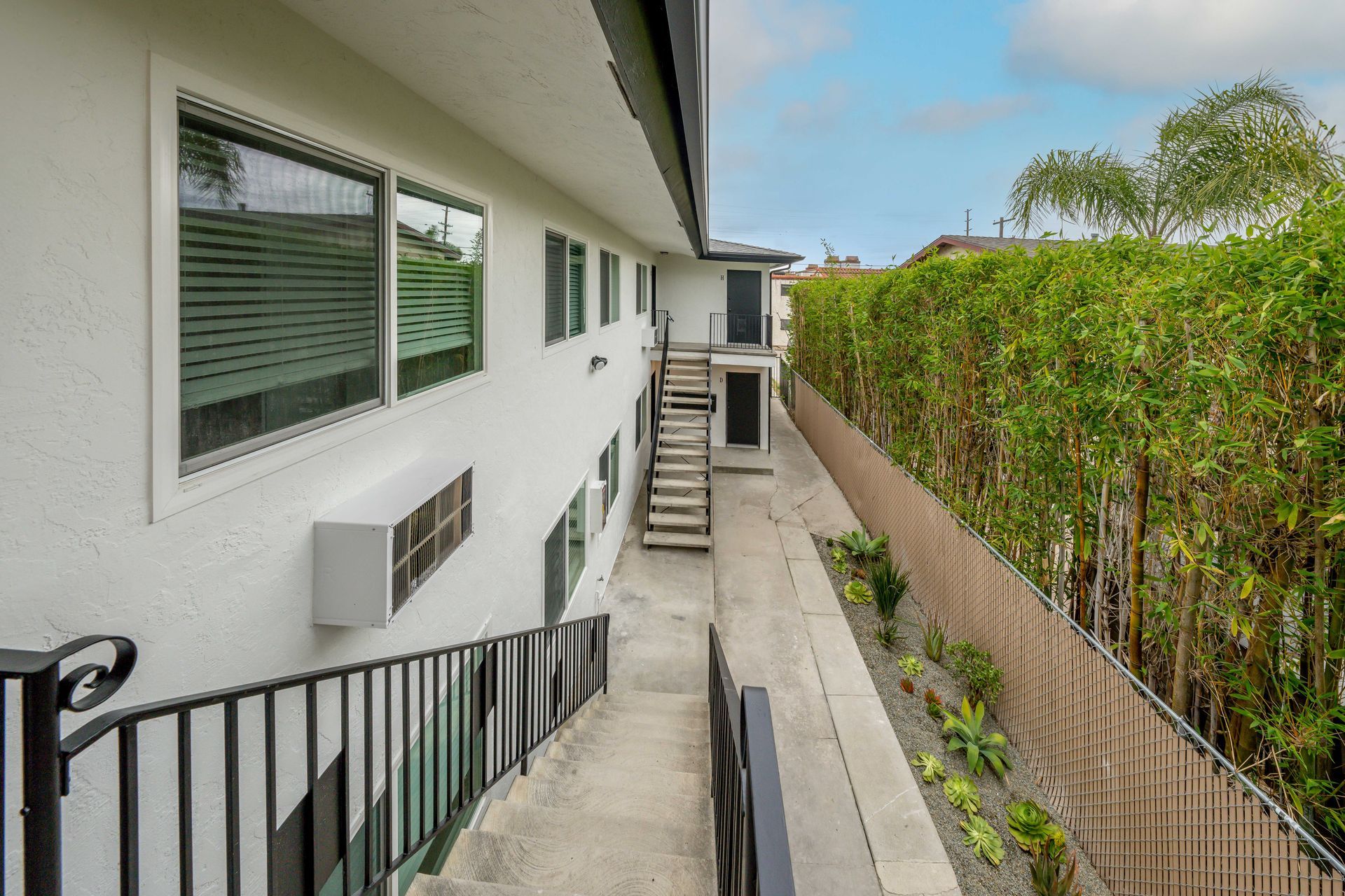 A white building with stairs leading up to it