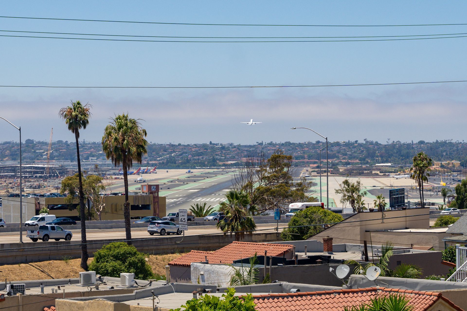 An aerial view of a city with palm trees in the foreground