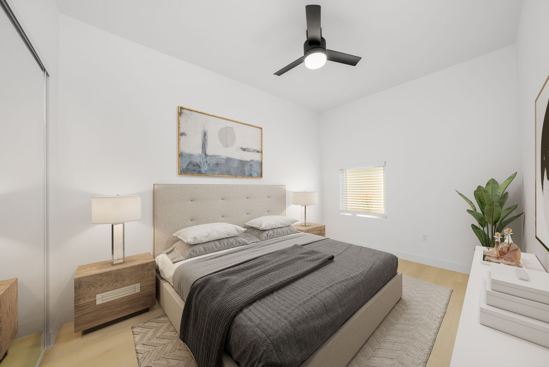 A bedroom with a large bed and a ceiling fan.