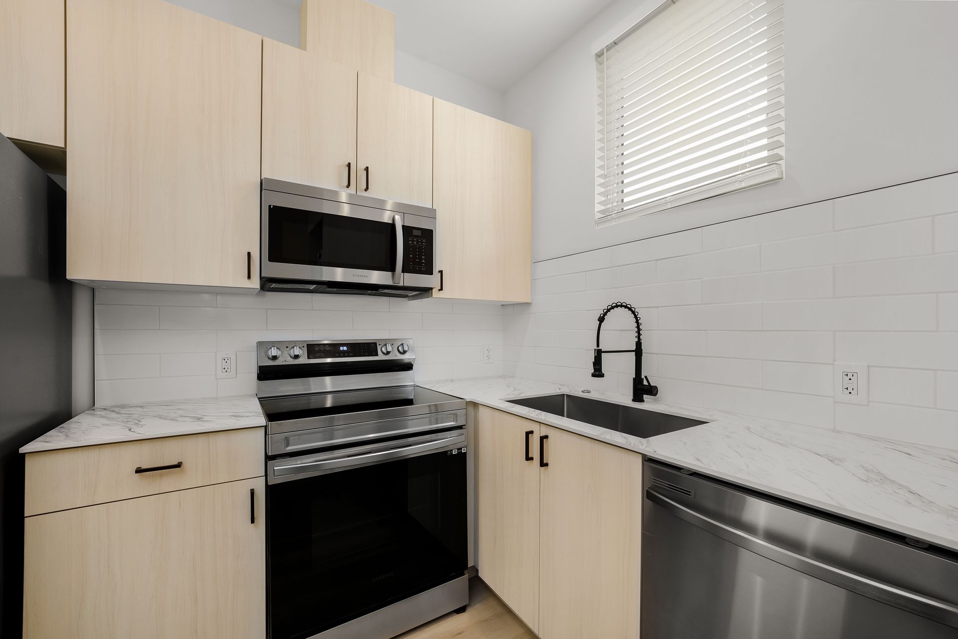 A kitchen with stainless steel appliances and wooden cabinets