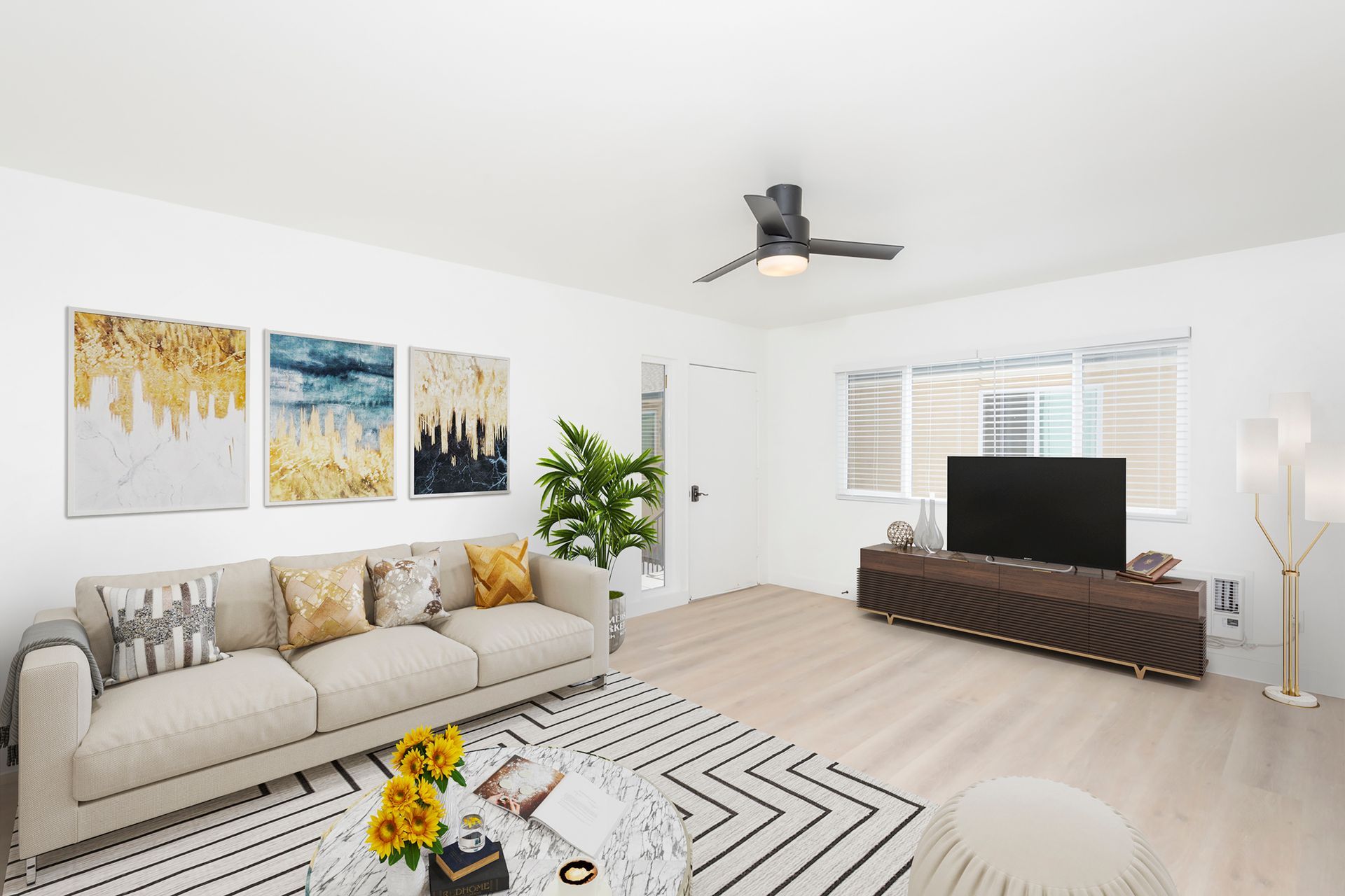 A living room with a couch , television , and ceiling fan.