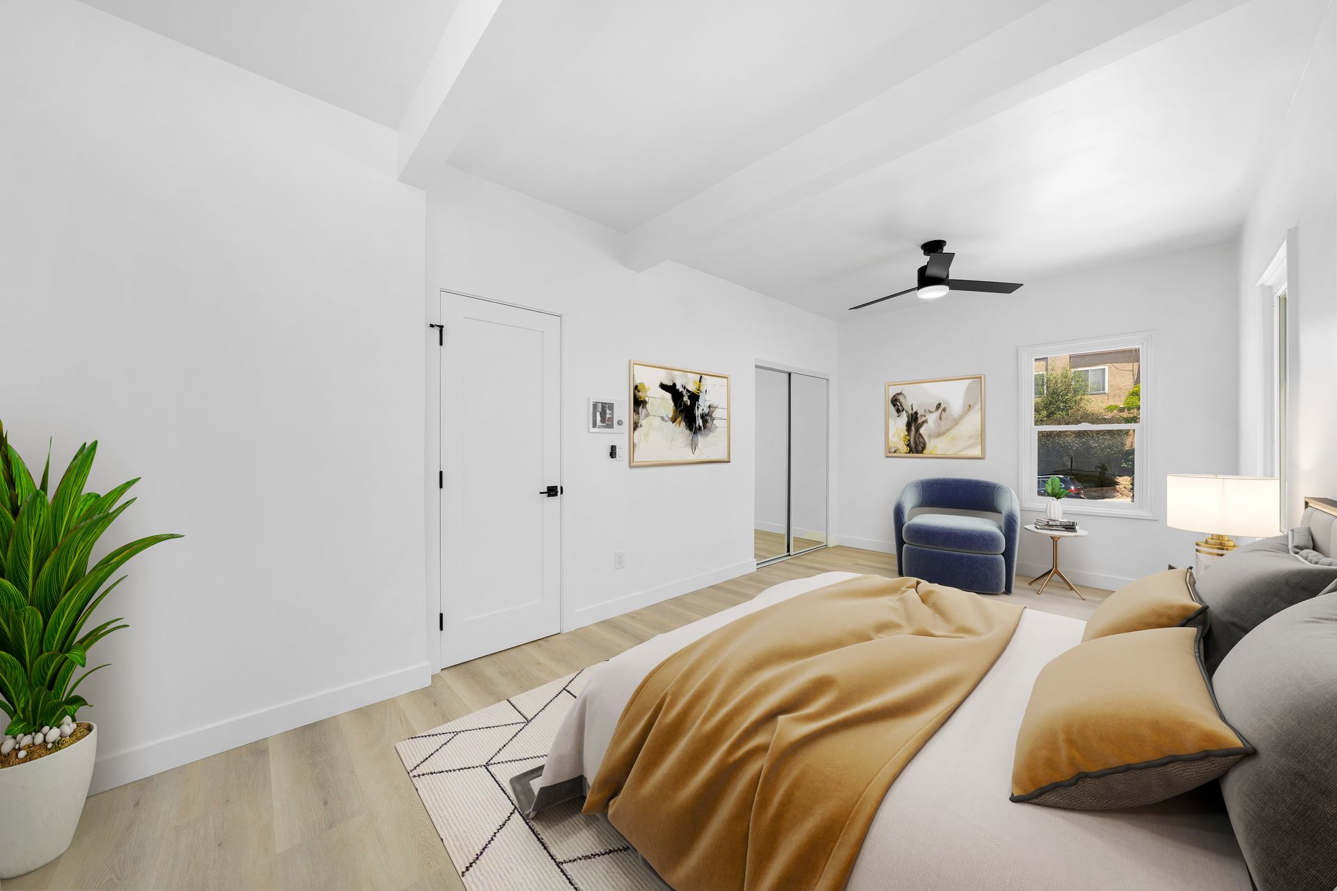 A bedroom with a bed , chair and ceiling fan.