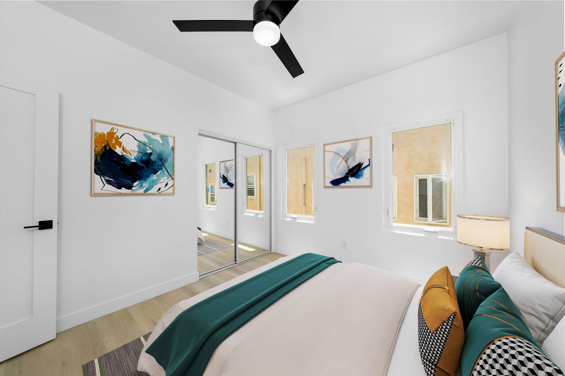 A bedroom with a bed and a ceiling fan