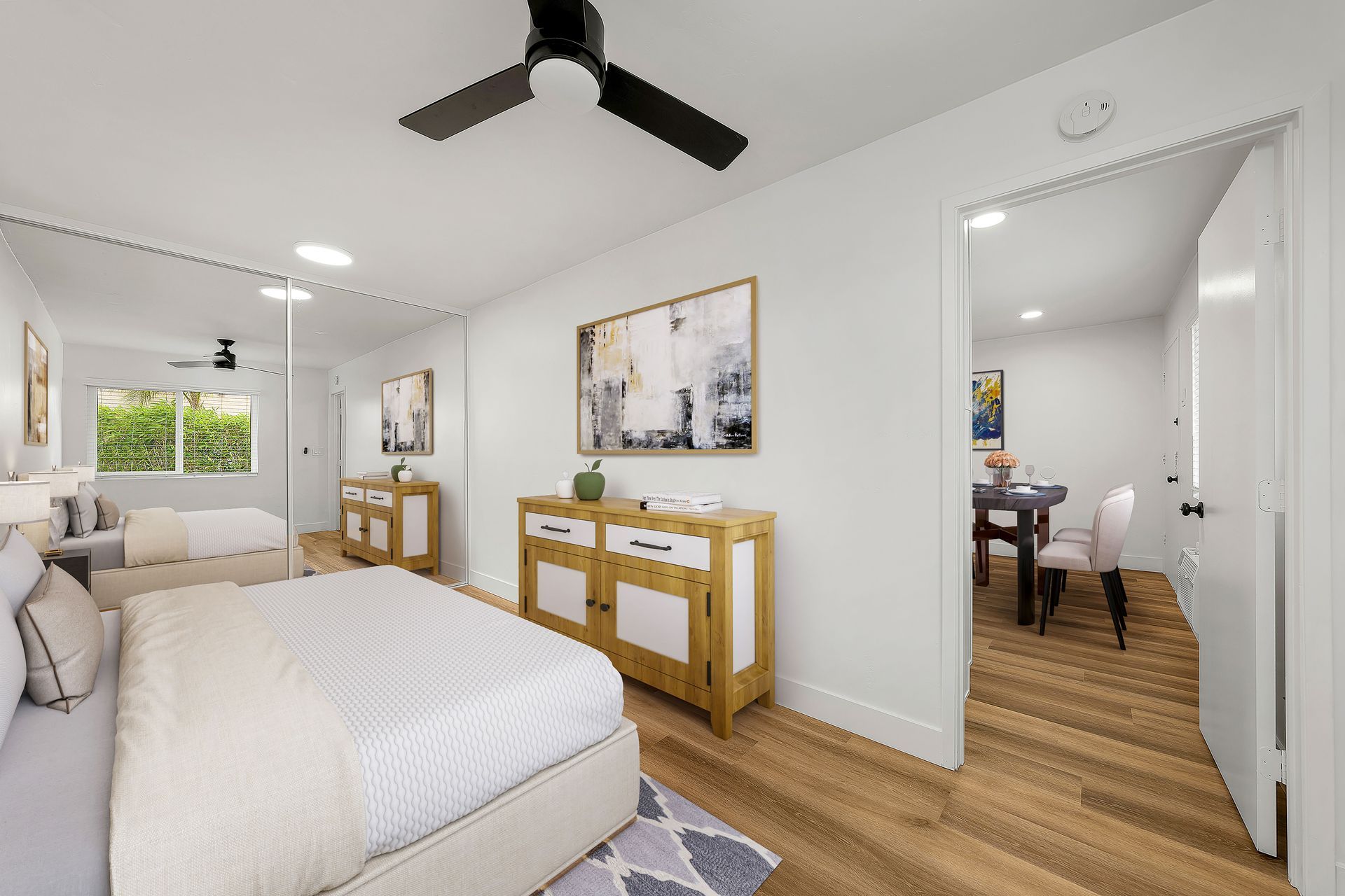 A bedroom with a large bed and a ceiling fan.