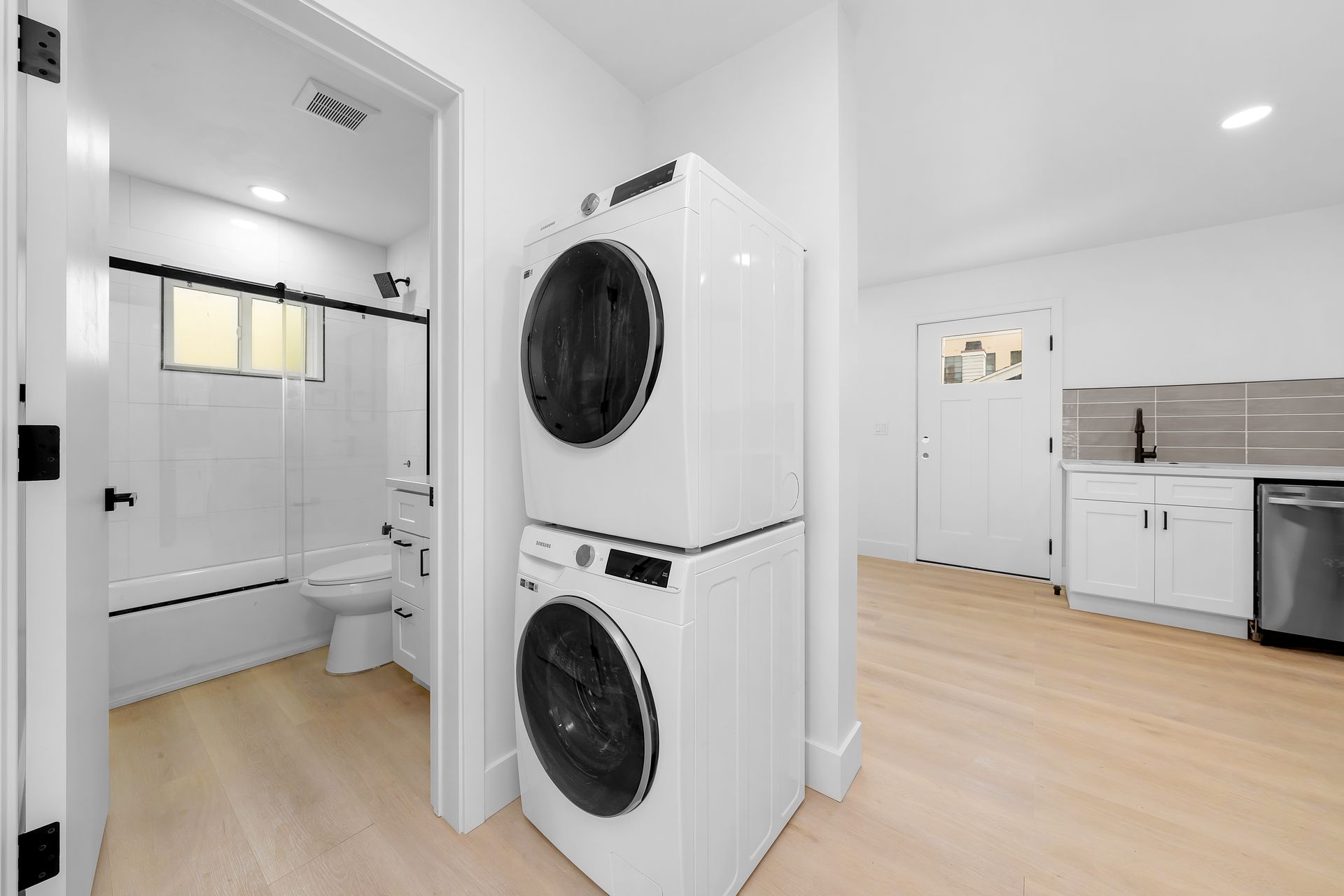 A washer and dryer are stacked on top of each other in a laundry room.