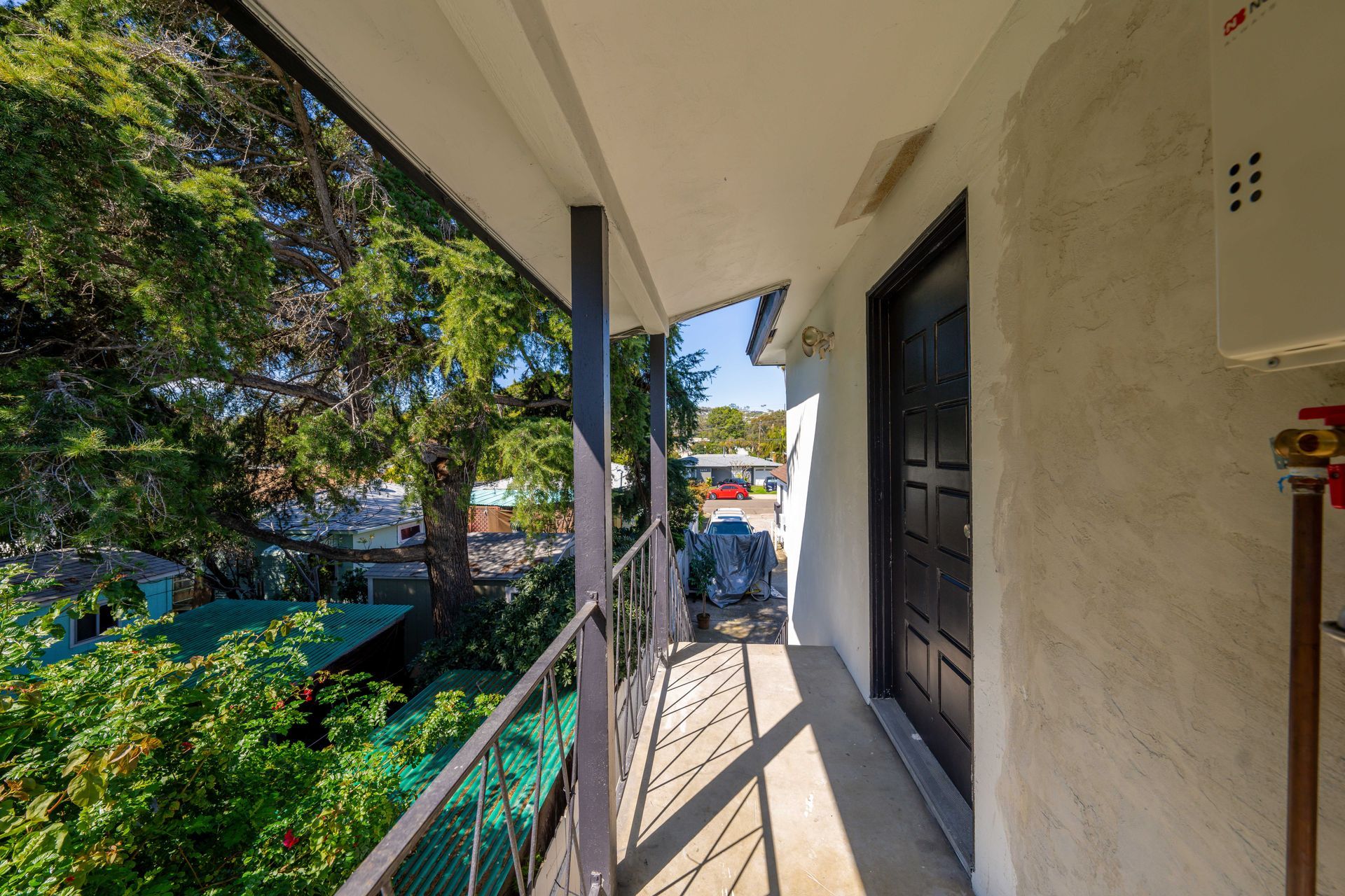 A balcony in a building with trees in the background