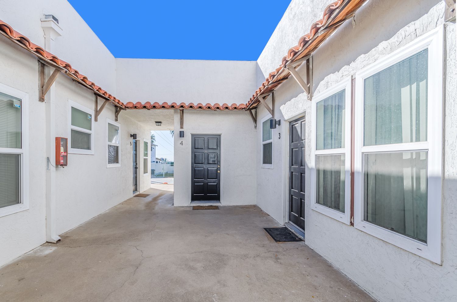 A white building with a blue sky in the background