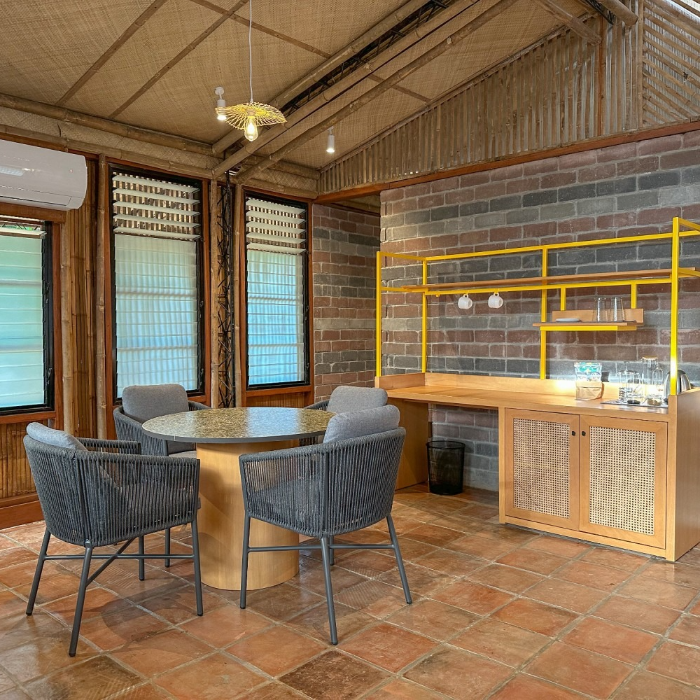 Bedroom with a large wooden headboard, two bedside tables with lamps, a vanity, and framed art.
