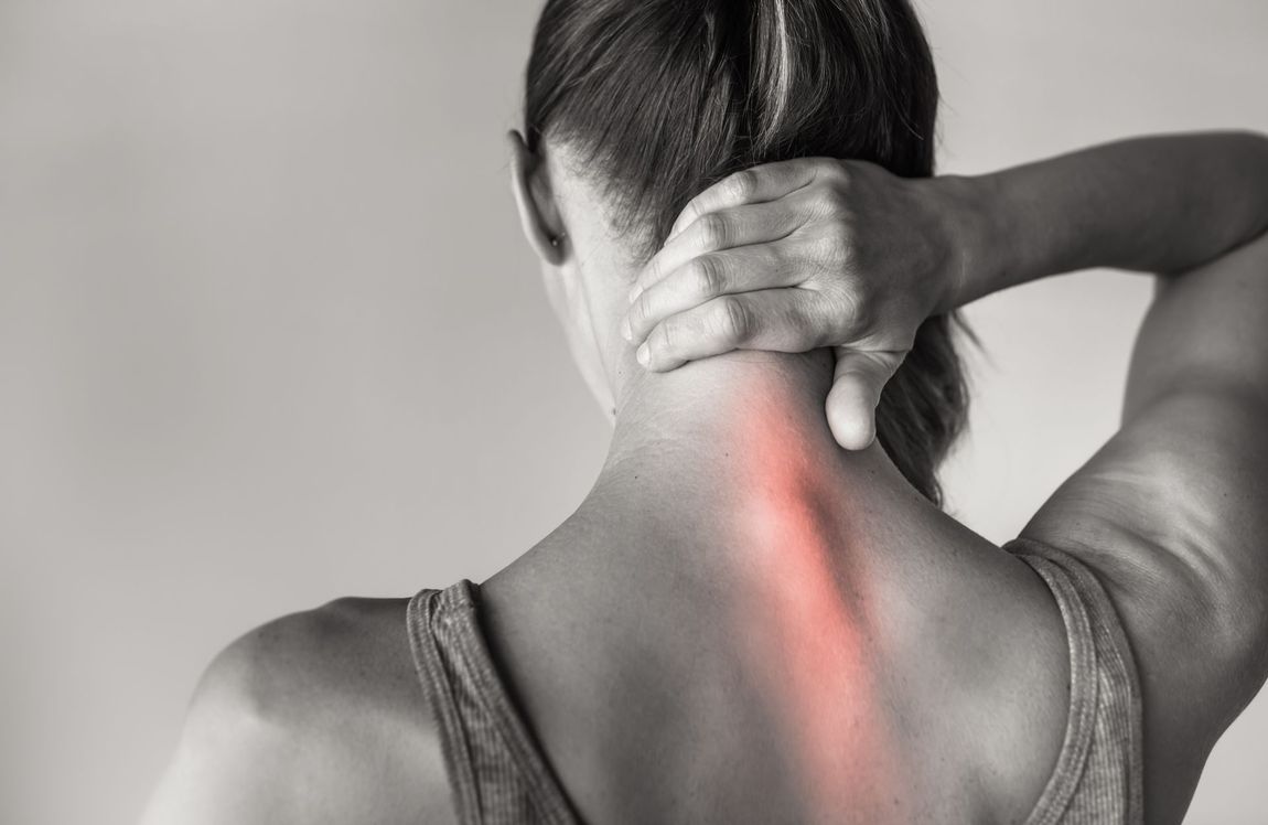 Woman holding her neck in pain, highlighting red spine.