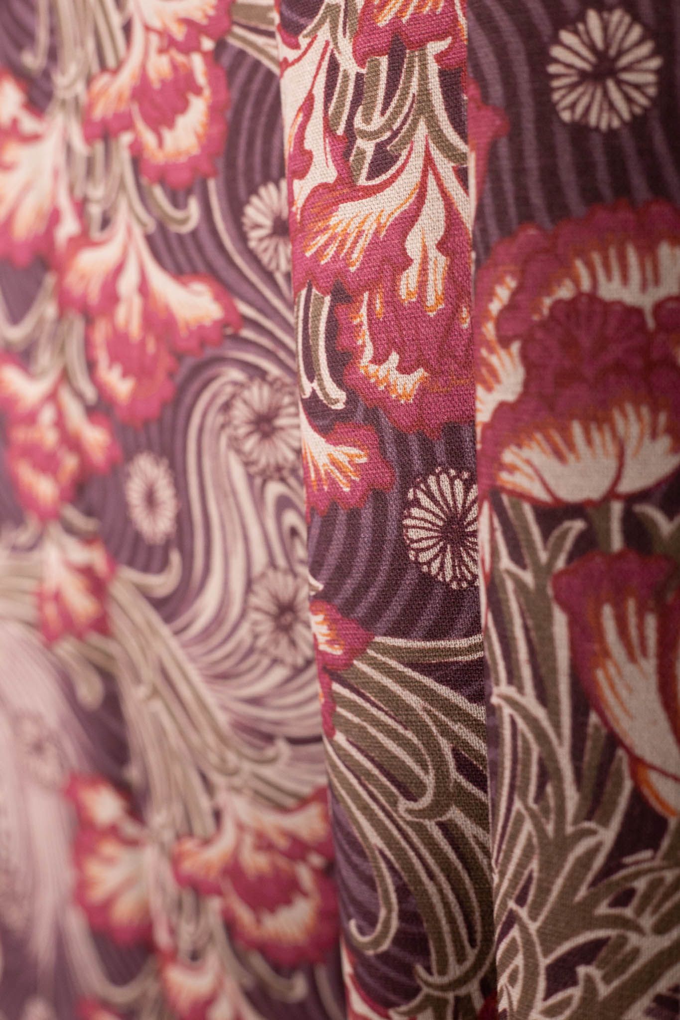 A close up of a curtain with a floral pattern on it.