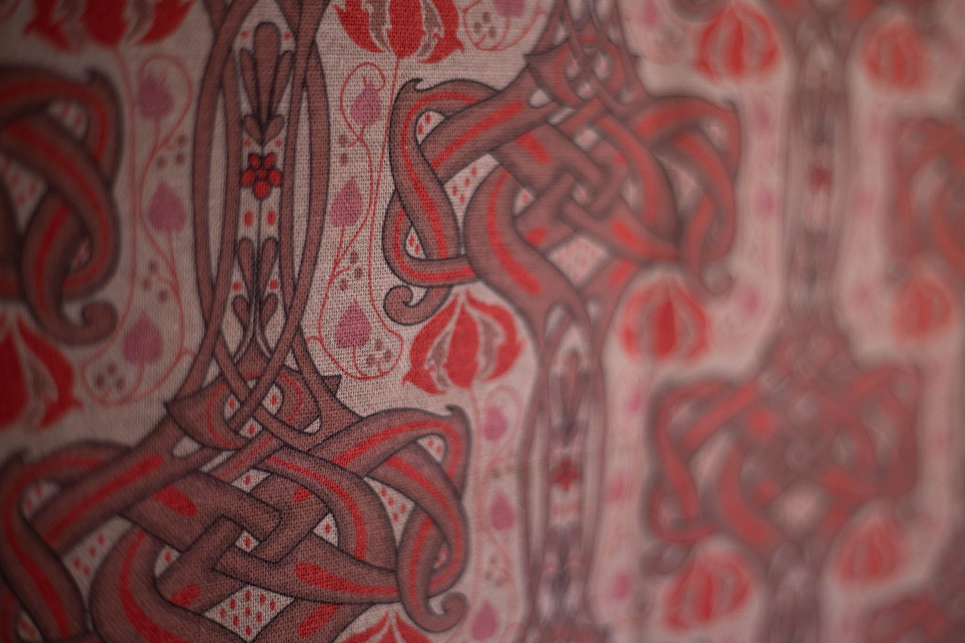 A close up of a red and white pattern on a wall.