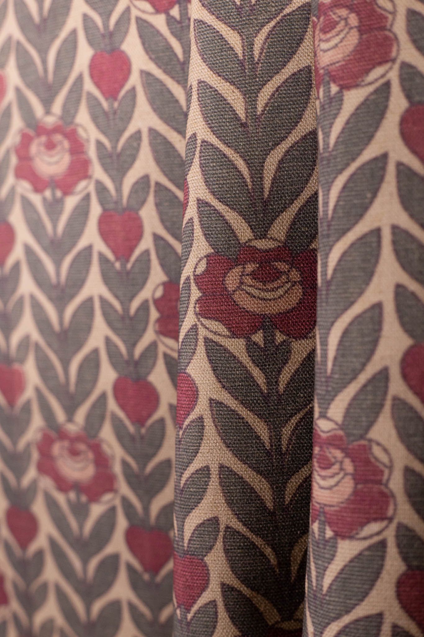 A close up of a curtain with a floral pattern on it.