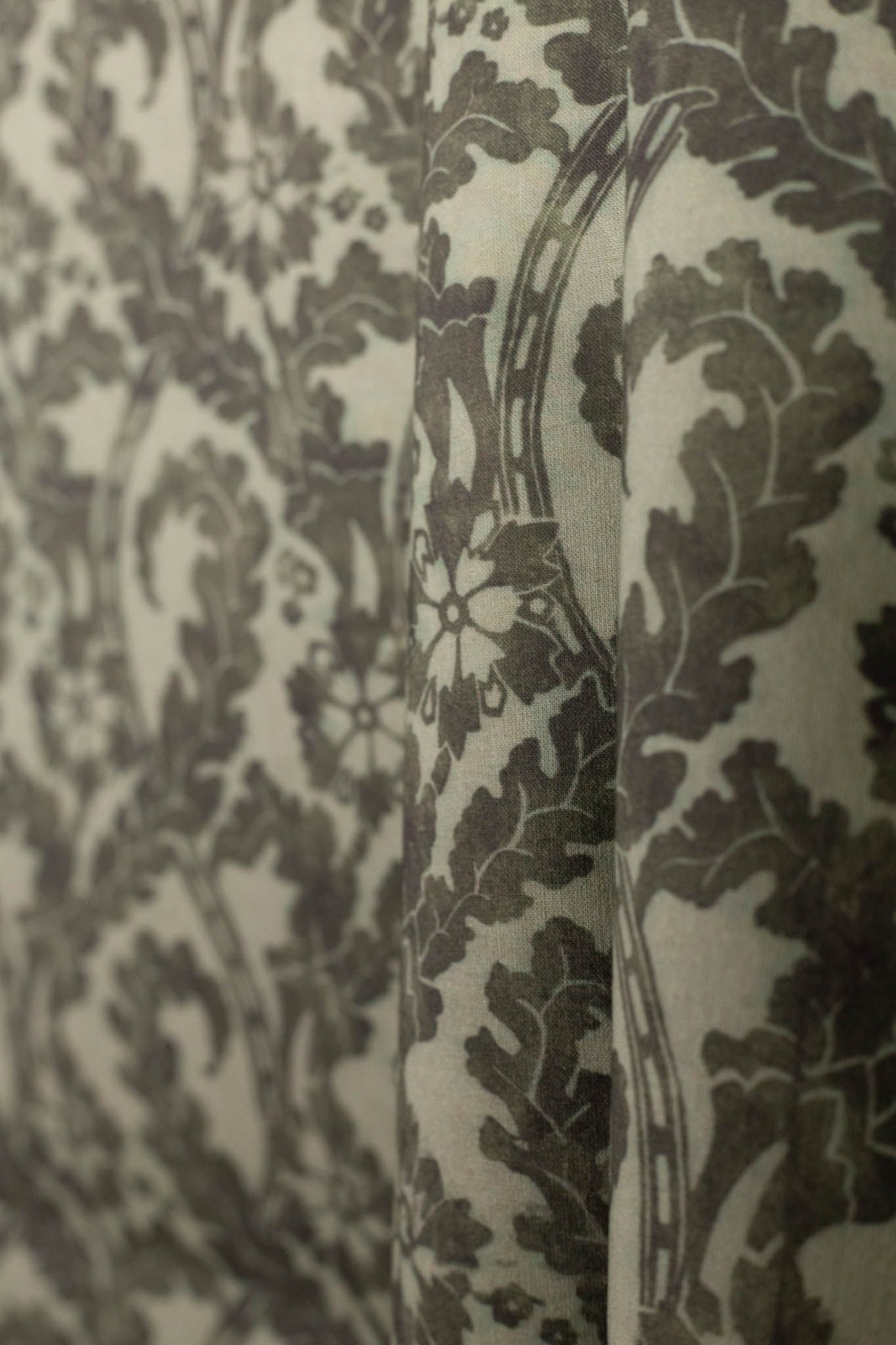 A close up of a couch with a floral pattern on it.