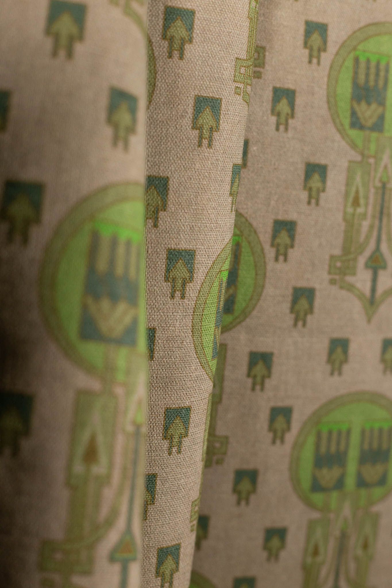 A close up of a piece of fabric with a green pattern