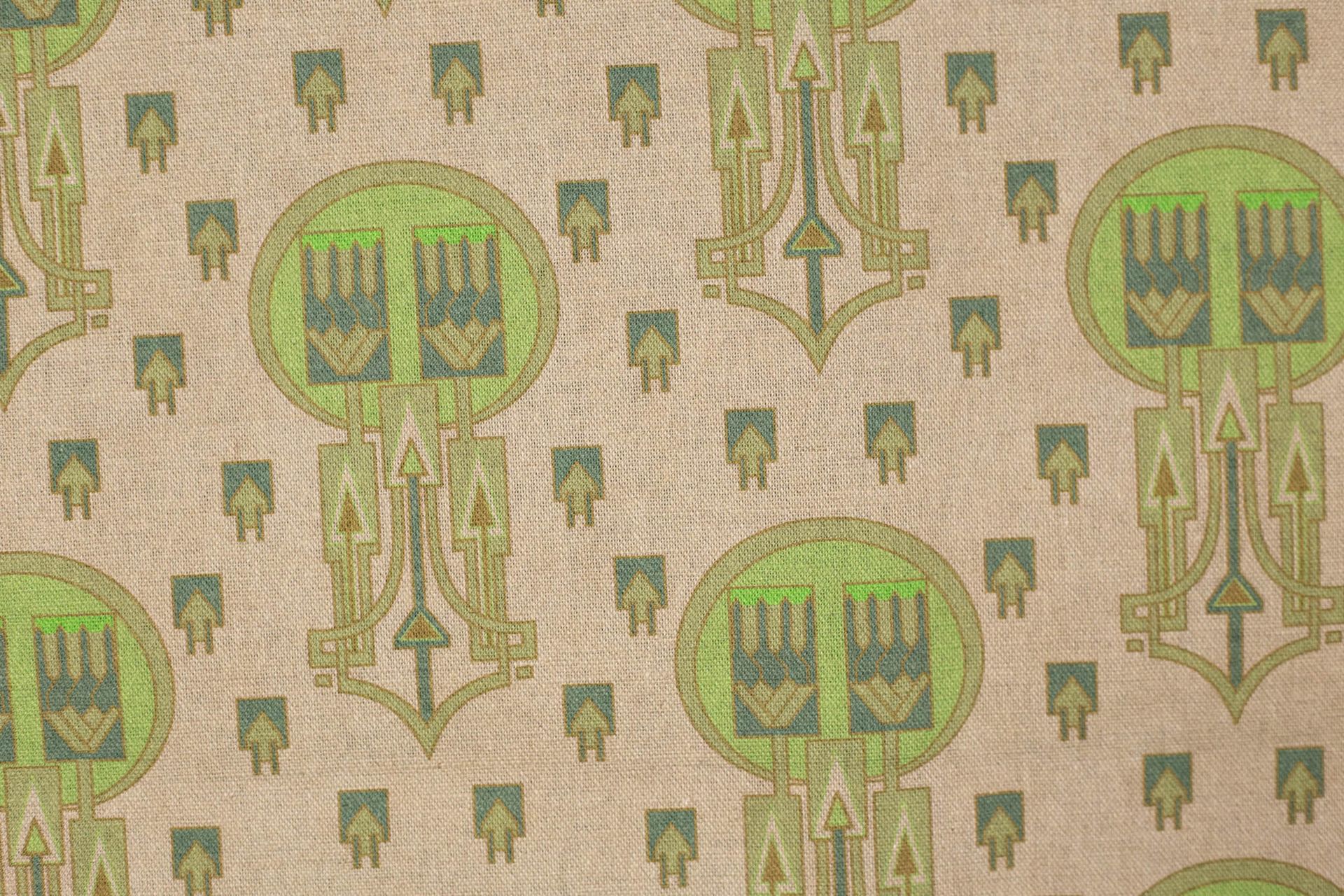 A close up of a piece of fabric with a green pattern