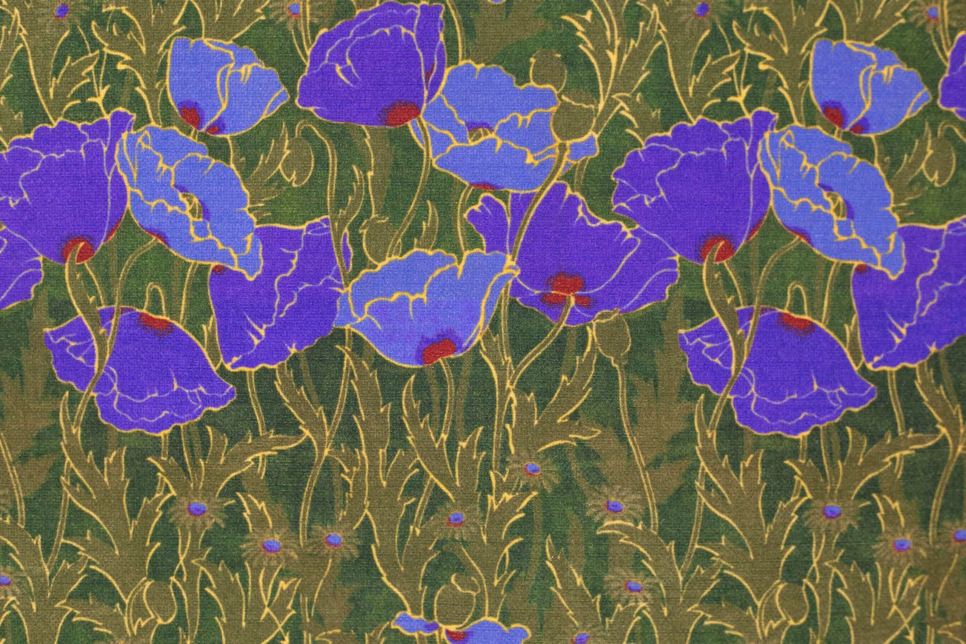 A close up of a green fabric with purple flowers on it.