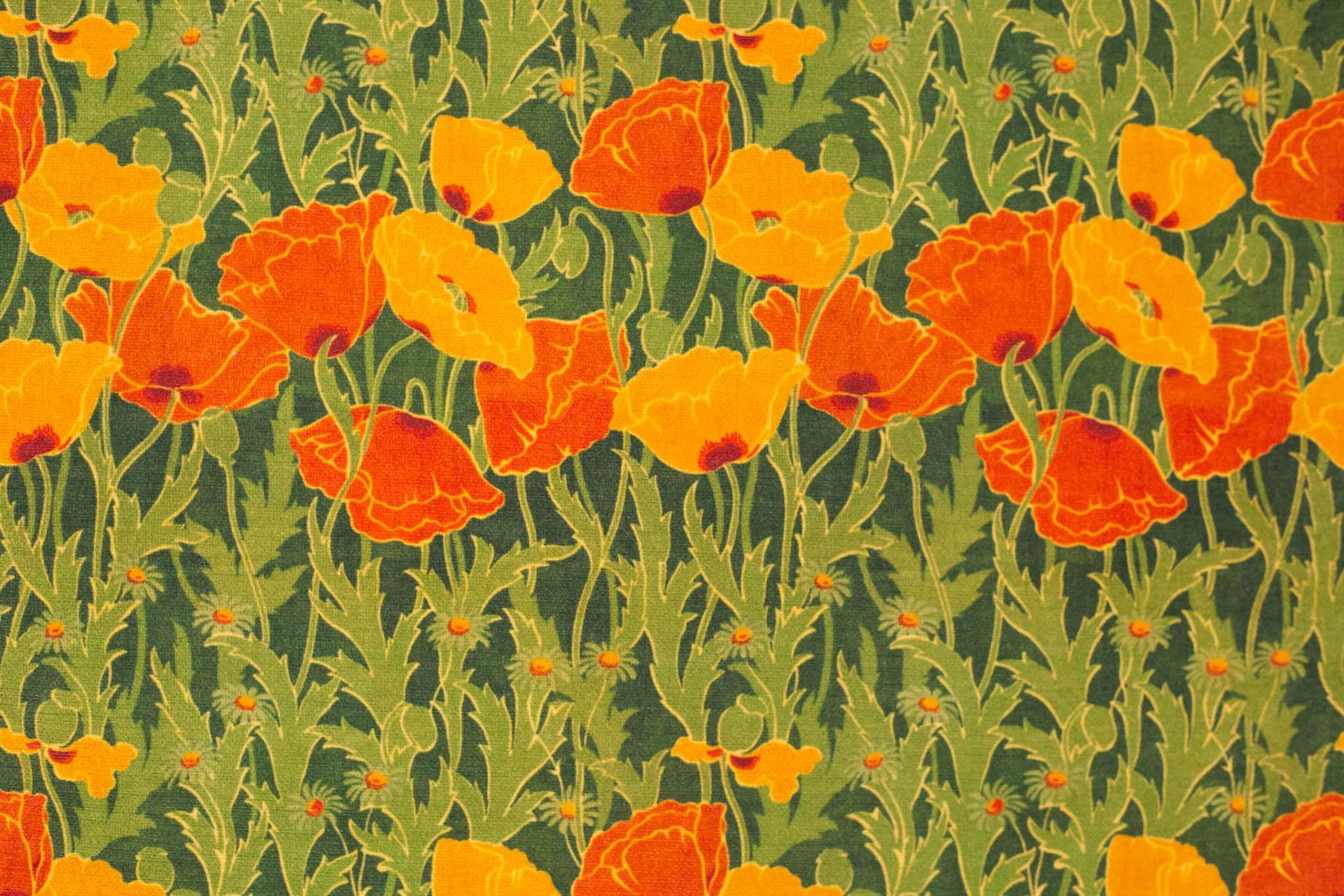 A pattern of orange and yellow flowers on a green background