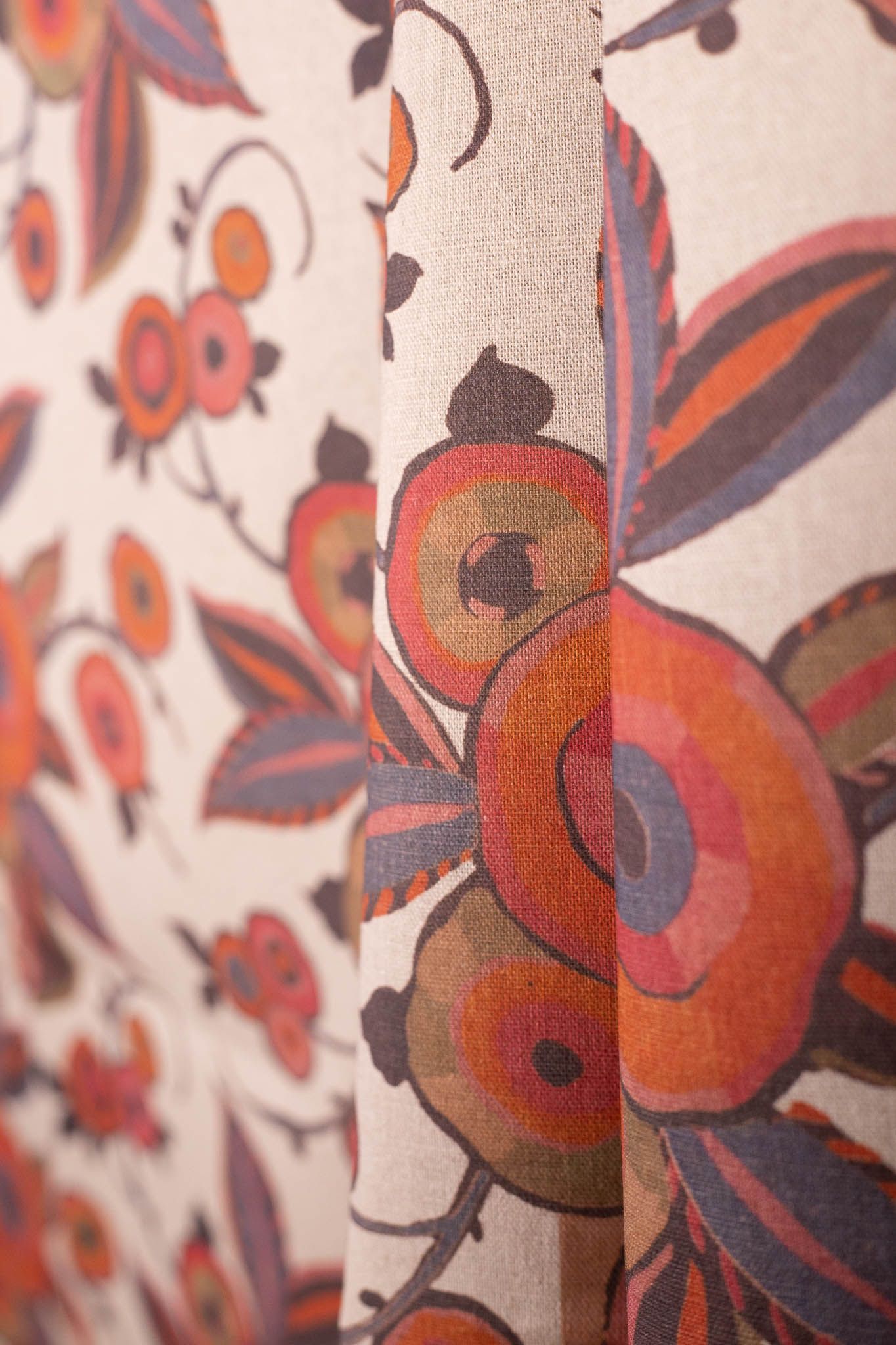 A close up of a curtain with a floral pattern on it.