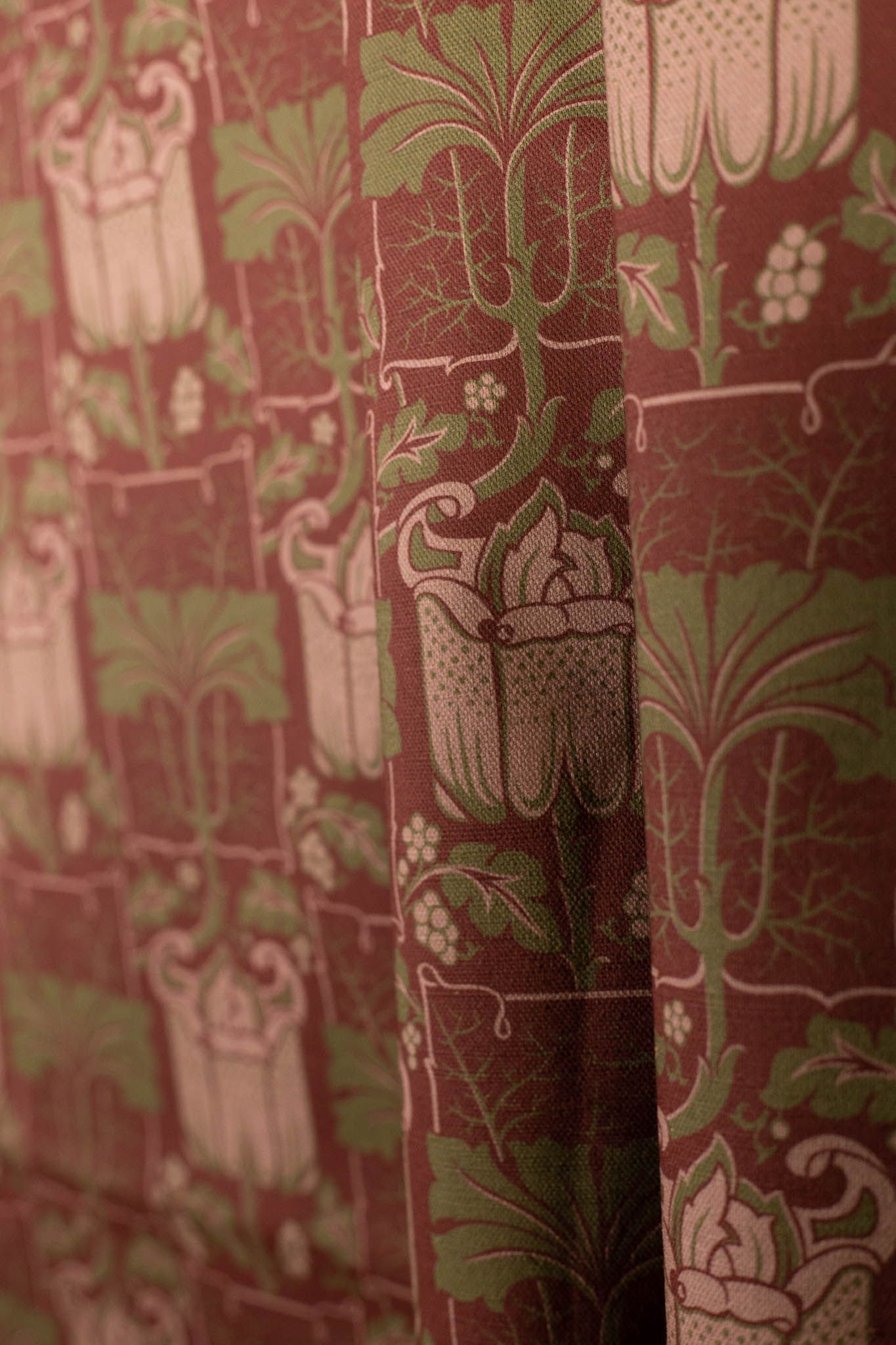 A close up of a curtain with a floral pattern on it.