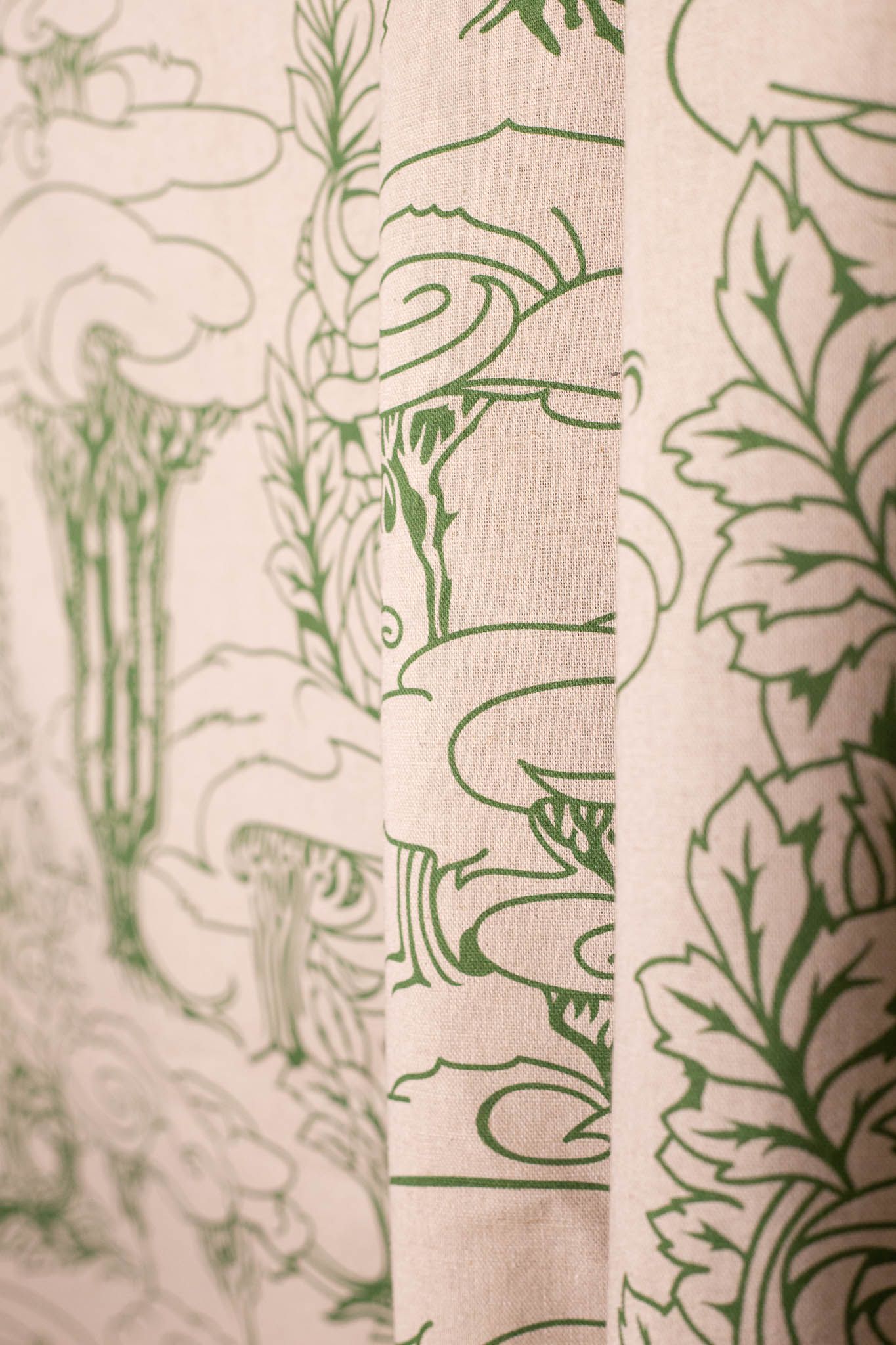 A close up of a curtain with a green and white pattern