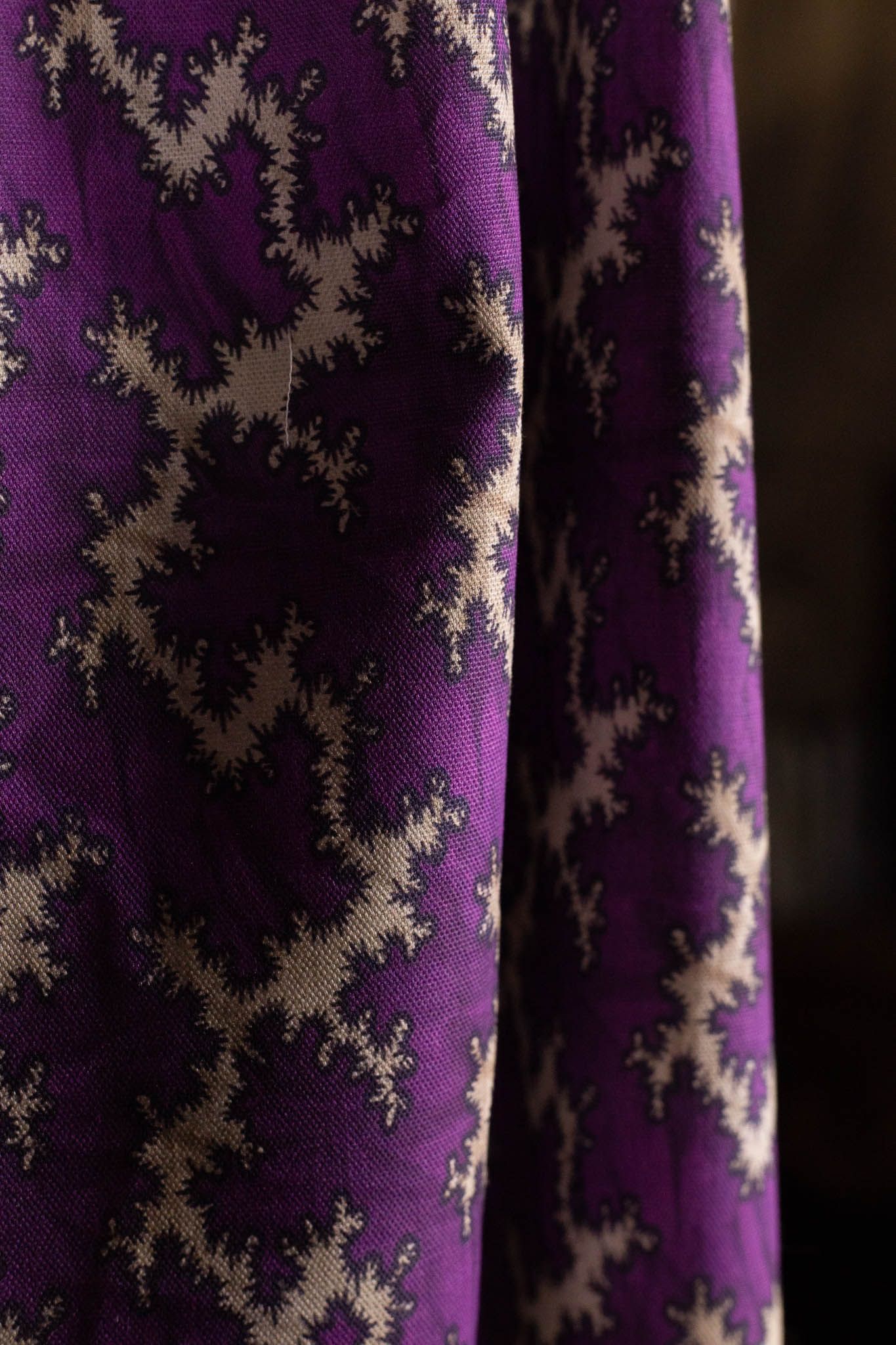 A close up of a purple fabric with a pattern on it.