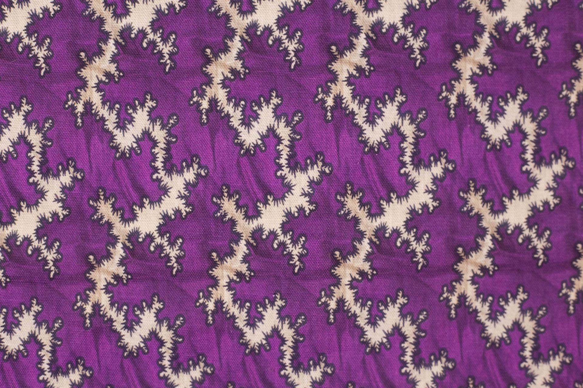 A close up of a purple fabric with a pattern on it.