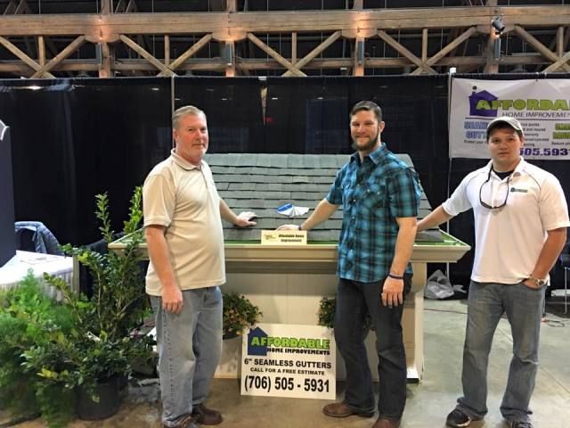 The team at a trade show for Affordable Home Improvements