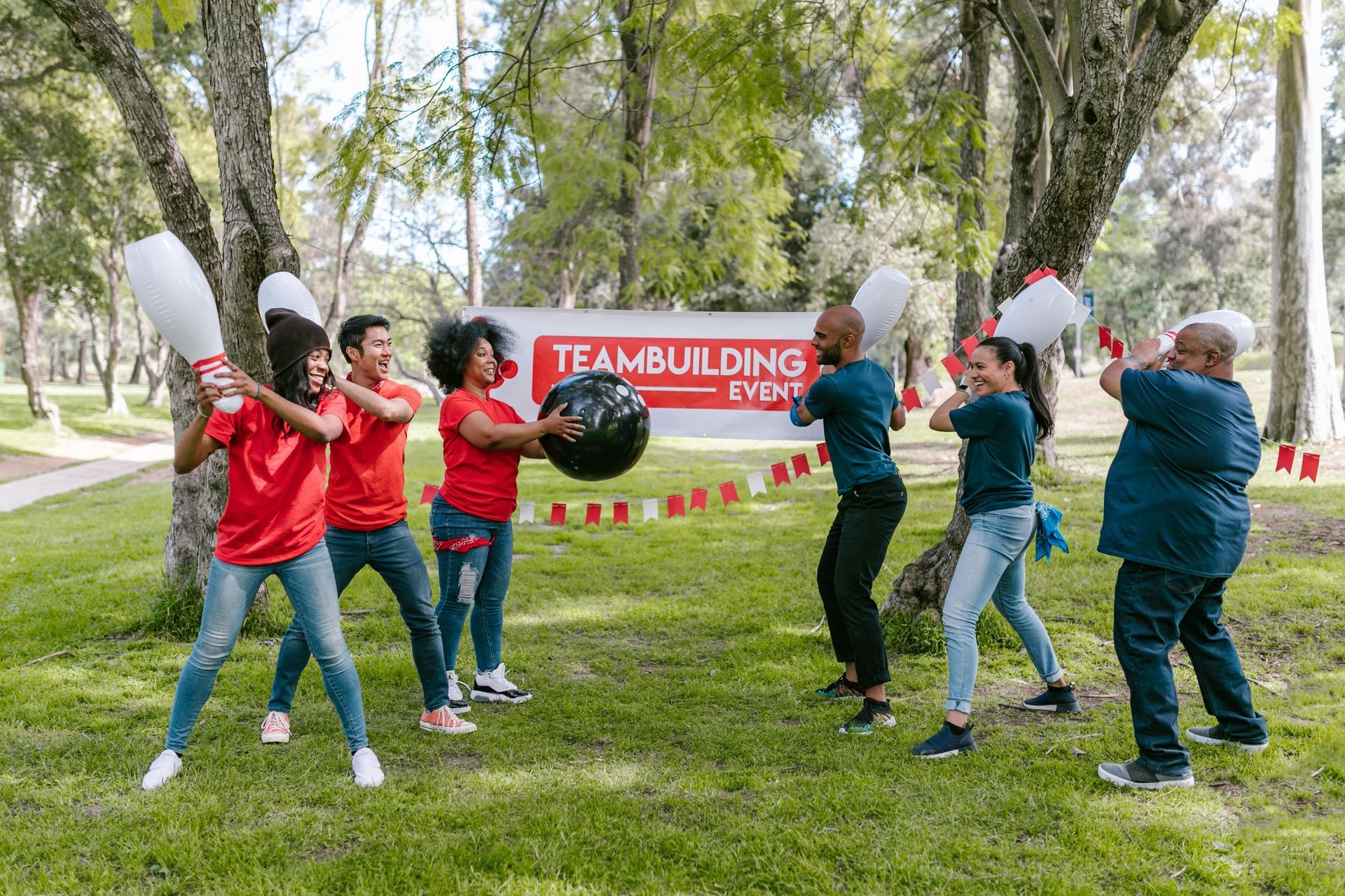 A group of people are playing a game in a park.
