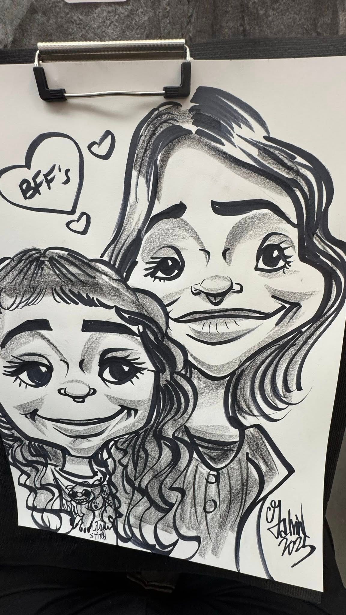 Black-and-white cartoon-style portrait of two smiling people with a heart and a speech bubble reading 